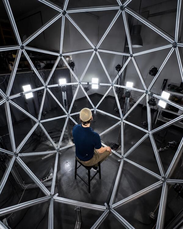 Metascan capture rig&mdash;actor seated inside the Light Cage during a scan