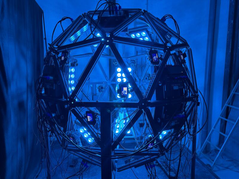 Metascan capture rig&mdash;actor seated inside the Light Cage during a scan